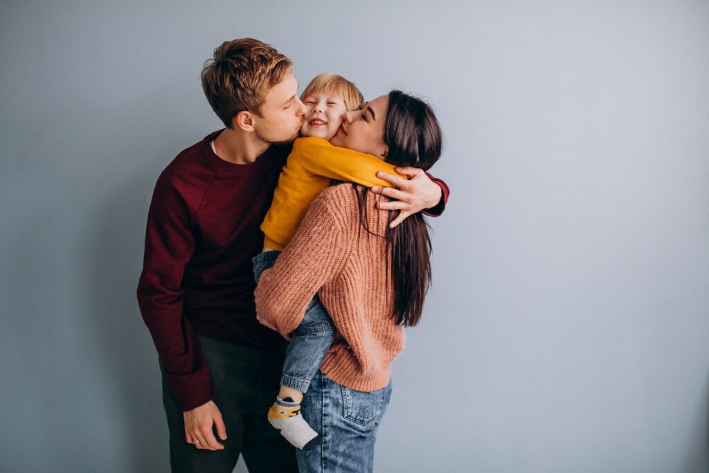 mom and dad showing affection to their child