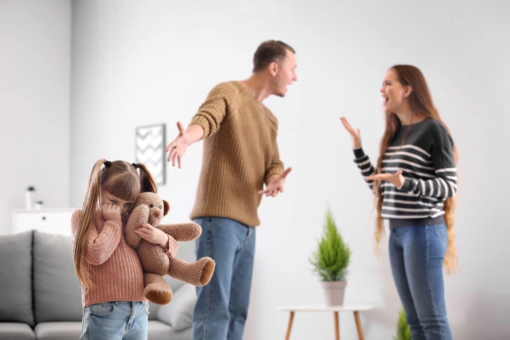 parents arguing in front of their small child