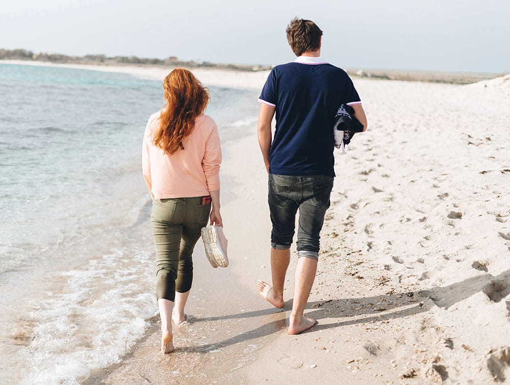a couple walking on the beach